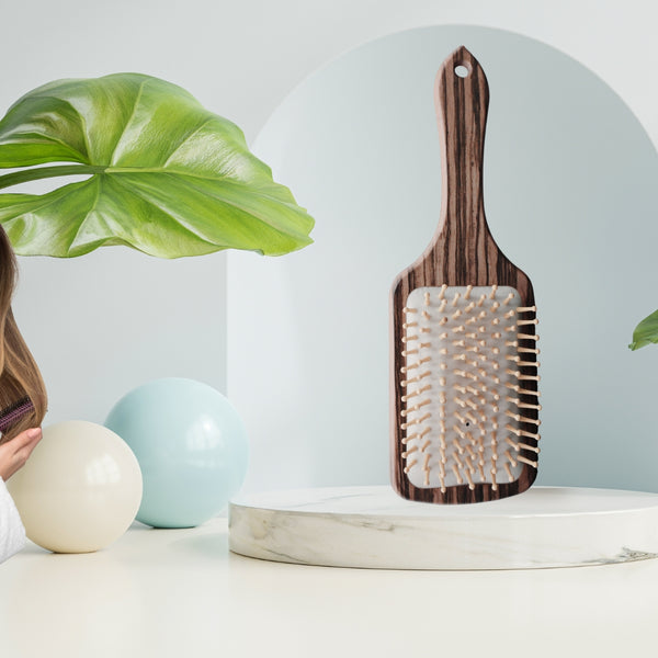 Wooden hairbrush with metal nibs