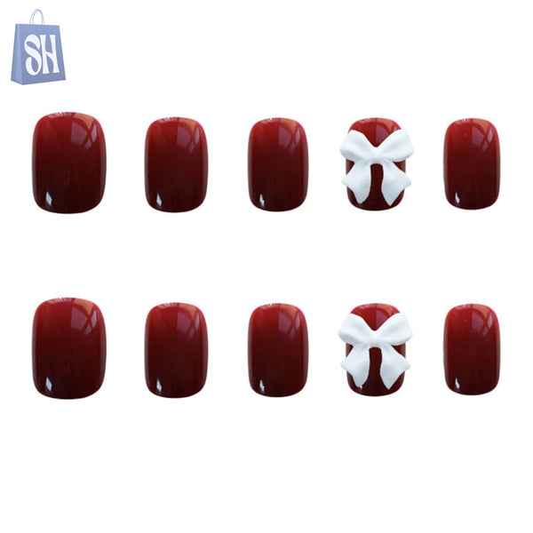 أظافر حمراء مع فيونكة بيضاء